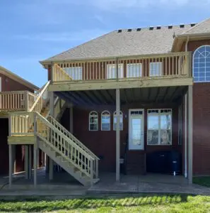 Large two story wooden deck with stairs built by the Asset Solution Company